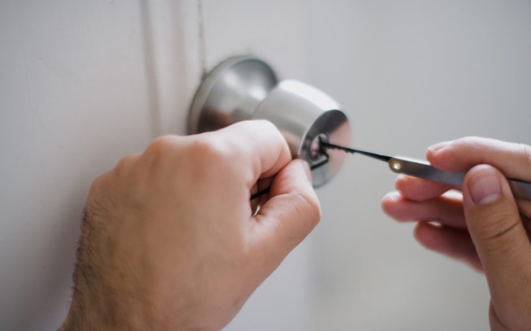 A locksmith engaged in lock repair, one of the common locksmith services