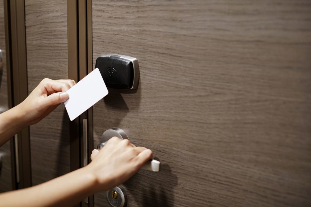 A woman uses a commercial access control system to get into a secure room